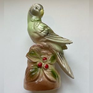 Vintage ceramic parakeet on holly.